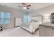 Bright bedroom features a ceiling fan, neutral tones, and a large window for natural light at 2557 7B Pete Dye Dr. # 704, North Myrtle Beach, SC 29582