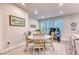 Cozy dining area with a round table, wooden chairs, and natural light from nearby windows at 2557 7B Pete Dye Dr. # 704, North Myrtle Beach, SC 29582