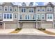 Charming townhouse exterior with stone accents, individual garages, and welcoming entrances at 2557 7B Pete Dye Dr. # 704, North Myrtle Beach, SC 29582