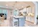 Modern kitchen boasts stainless steel appliances, a center island with seating, and stylish white cabinetry at 2557 7B Pete Dye Dr. # 704, North Myrtle Beach, SC 29582