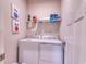 Functional laundry room with a washer, dryer, storage shelves, and bright lighting at 2557 7B Pete Dye Dr. # 704, North Myrtle Beach, SC 29582