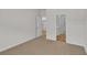 Bedroom with neutral carpet and access to laundry room, bedroom, and en-suite bathroom at 794 Nw Palm Frond Way # 48, Calabash, NC 28467