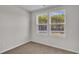 Bedroom featuring two windows, neutral carpet, and white walls for customization at 794 Nw Palm Frond Way # 48, Calabash, NC 28467