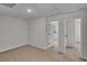 Neutral bedroom showcases a door, carpeted floors, and bright white walls at 794 Nw Palm Frond Way # 48, Calabash, NC 28467