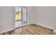 Bright room with wood-look floors, sliding glass doors to a outdoor view of a pond at 794 Nw Palm Frond Way # 48, Calabash, NC 28467