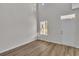 Bright living room featuring wood floors, large windows, tall ceilings, and a white entry door at 794 Nw Palm Frond Way # 48, Calabash, NC 28467