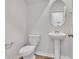 Powder room with a pedestal sink, toilet, oval mirror, and classic fixtures at 794 Nw Palm Frond Way # 48, Calabash, NC 28467