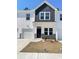 Charming townhome with white siding, shingle accent, a one-car garage, and a well-maintained lawn at 796 Nw Palm Frond Way # 47, Calabash, NC 28467