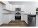 Modern kitchen with stainless steel appliances, granite counters, and white cabinetry at 796 Nw Palm Frond Way # 47, Calabash, NC 28467
