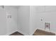 Clean laundry room with dark wood floors and utility connections, providing a practical space at 796 Nw Palm Frond Way # 47, Calabash, NC 28467