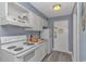 Compact kitchen featuring white appliances, including a range and refrigerator, for convenient meal preparation at 1207 S Ocean Blvd. # 51408, Myrtle Beach, SC 29577
