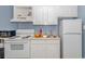Efficient kitchen space equipped with a range, refrigerator, and ample cabinet space for storage and functionality at 1207 S Ocean Blvd. # 51408, Myrtle Beach, SC 29577