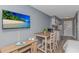 Open-concept living area with a dining table, kitchen, and entertainment amenities, all in one cozy space at 1207 S Ocean Blvd. # 51408, Myrtle Beach, SC 29577