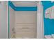 Clean shower area with white walls and blue accents, providing a simple and functional space for daily routines at 1207 S Ocean Blvd. # 51408, Myrtle Beach, SC 29577