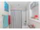 Bathroom with a shower-tub combo, striped shower curtain, and decorative window with plenty of natural light at 136 Kenzgar Dr., Myrtle Beach, SC 29588