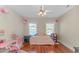 Bedroom with a cozy bed, whimsical decor, natural light, and wood flooring at 136 Kenzgar Dr., Myrtle Beach, SC 29588