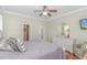 Cozy bedroom with wood floors, a neutral color scheme, and a white dresser with a decorative mirror at 136 Kenzgar Dr., Myrtle Beach, SC 29588