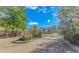 Gated community entrance featuring brick pillars and lush landscaping under a bright sky at 136 Kenzgar Dr., Myrtle Beach, SC 29588