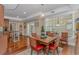 A dining room features a wooden table with seating, wood floors, and natural light from the large window at 136 Kenzgar Dr., Myrtle Beach, SC 29588