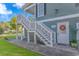 Side entrance with decorative wreath and outdoor staircase providing access to the home at 136 Kenzgar Dr., Myrtle Beach, SC 29588
