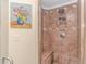 Walk-in shower featuring neutral tile, a built-in bench, and rainfall shower head at 136 Kenzgar Dr., Myrtle Beach, SC 29588