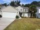Charming two-story home with a well-manicured lawn and a two-car garage at 156 Weeping Willow Dr., Myrtle Beach, SC 29579