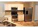 Well-equipped kitchen featuring stainless steel appliances, white cabinets, and tile flooring at 156 Weeping Willow Dr., Myrtle Beach, SC 29579