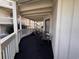 A covered outdoor patio with chairs and an view of other buildings at 2805 N Ocean Blvd. # 107, Myrtle Beach, SC 29577