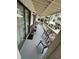 This covered outdoor patio has multiple chairs, a small table, and a view of the pool area at 2805 N Ocean Blvd. # 107, Myrtle Beach, SC 29577