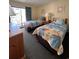 This is a cozy bedroom with beach-themed decor, two beds, and a balcony access at 2805 N Ocean Blvd. # 107, Myrtle Beach, SC 29577