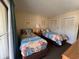 Cozy bedroom with beach-themed decor, two beds, and a balcony access at 2805 N Ocean Blvd. # 107, Myrtle Beach, SC 29577