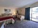 Cozy bedroom with two beds, neutral walls, and a sliding glass door to a balcony at 2805 N Ocean Blvd. # 107, Myrtle Beach, SC 29577
