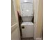 White stacked washer and dryer in a small laundry area at 2805 N Ocean Blvd. # 107, Myrtle Beach, SC 29577