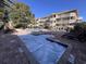 Community pool and whirlpool with lounge chairs near a multi-story building at 2805 N Ocean Blvd. # 107, Myrtle Beach, SC 29577