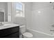 Bathroom with black vanity, tiled shower, and matching toilet at 608 Britt St., Georgetown, SC 29440