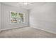Bright bedroom with neutral carpet, a ceiling fan, and a view of the landscaped yard at 608 Britt St., Georgetown, SC 29440