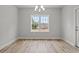 Light-filled dining room with wood floors, a charming chandelier, and backyard views at 608 Britt St., Georgetown, SC 29440