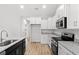 Modern kitchen with white cabinets, stainless steel appliances, and elegant granite countertops at 608 Britt St., Georgetown, SC 29440