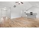 Open-concept living room with hardwood floors, vaulted ceilings, and a modern kitchen at 608 Britt St., Georgetown, SC 29440