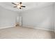 Large carpeted main bedroom with tray ceiling and ceiling fan, offering a tranquil retreat at 608 Britt St., Georgetown, SC 29440