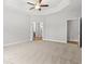 Expansive main bedroom featuring soft carpeting, a tray ceiling with fan, and ensuite access at 608 Britt St., Georgetown, SC 29440