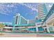 View of the Landmark Resort building exterior with palm trees and street view at 1501 Ocean Blvd. S # 422, Myrtle Beach, SC 29577