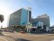 Modern resort building with a mix of blue and white exterior, plus ample parking spaces at 1501 Ocean Blvd. S # 422, Myrtle Beach, SC 29577