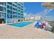 Exterior pool with multiple lounge chairs in a resort setting on a sunny day at 1501 Ocean Blvd. S # 422, Myrtle Beach, SC 29577