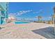 Exterior pool with chairs and palm trees near a resort building with balconies at 1501 Ocean Blvd. S # 422, Myrtle Beach, SC 29577