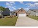 Charming single-Gathering home featuring a stone facade, attached two-car garage, and well-manicured lawn in a vibrant community at 181 Ocean Commons Dr., Surfside Beach, SC 29575