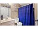 Compact bathroom featuring a toilet, sink, and a shower/tub combination with blue shower curtain at 3735 Block House Way # 113, Myrtle Beach, SC 29577