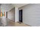 Condo front entrance featuring a black door with the number 113, a welcome mat, and neutral siding at 3735 Block House Way # 113, Myrtle Beach, SC 29577