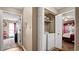 Hallway with laundry closet featuring a washer and dryer, conveniently located between the bedrooms at 3735 Block House Way # 113, Myrtle Beach, SC 29577