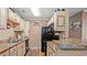 Well-equipped kitchen with black appliances, including a refrigerator and stove, complemented by wooden cabinets at 3735 Block House Way # 113, Myrtle Beach, SC 29577